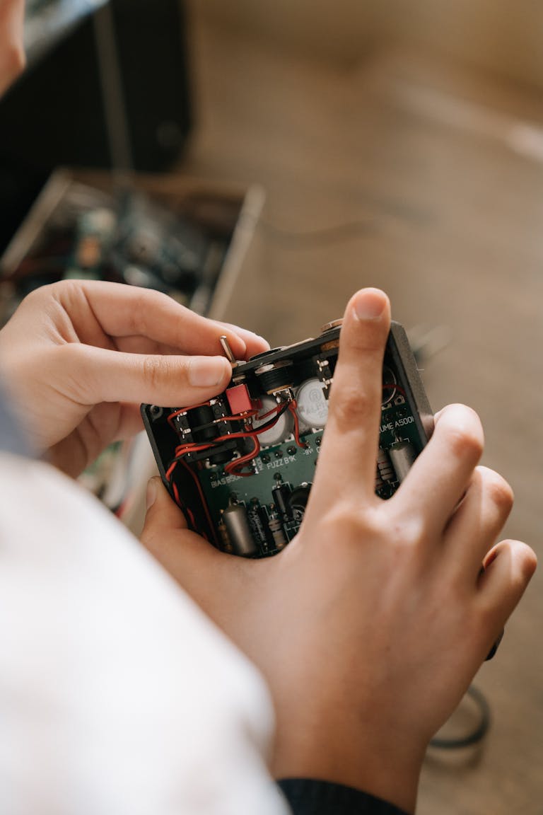 Person Holding Red and Black Toy Car